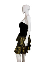 Load image into Gallery viewer, Mannequin wearing a black and gold dress against a plain wall.