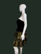 Load image into Gallery viewer, Mannequin wearing a black and gold dress against a plain wall.