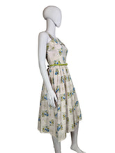 Load image into Gallery viewer, Floral dress on a mannequin against a plain wall.