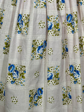 Load image into Gallery viewer, Floral patterned fabric with blue and green flowers on a white background