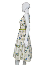 Load image into Gallery viewer, Mannequin wearing a floral dress against a plain wall.