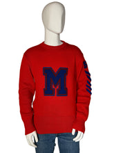 Load image into Gallery viewer, Red sweater with a blue 'M' logo on a mannequin against a gray background