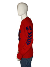 Load image into Gallery viewer, Red sweater with blue patterns on a mannequin against a plain background