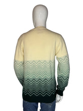 Load image into Gallery viewer, Mannequin wearing a cream sweater with green patterned sleeves on a plain background