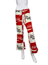 Load image into Gallery viewer, Mannequin wearing red and white Coca-Cola pants.