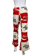 Load image into Gallery viewer, Red and white pants with Coca-Cola branding on a mannequin against a plain wall.
