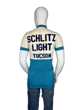 Load image into Gallery viewer, Mannequin wearing a vintage cycling jersey with 'Schlitz Light Tucson' text on a plain background