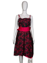 Load image into Gallery viewer, Red and black patterned dress on a mannequin against a white wall.