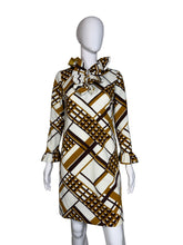 Load image into Gallery viewer, Mannequin wearing a patterned dress with geometric design on a plain background