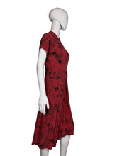 Load image into Gallery viewer, Red dress with black patterns on a white mannequin against a plain background