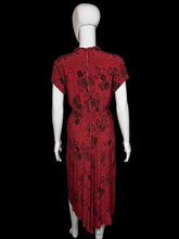 Load image into Gallery viewer, Red patterned garment on a mannequin against a white background