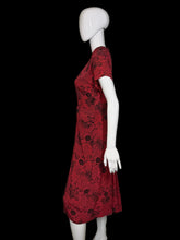 Load image into Gallery viewer, Red floral dress on a mannequin against a white background