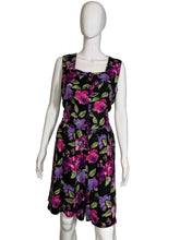 Load image into Gallery viewer, Black romper with colorful floral pattern on a mannequin against a white background