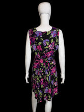 Load image into Gallery viewer, Black romper with colorful floral pattern on a mannequin against a white background