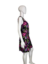 Load image into Gallery viewer, Black romper with colorful floral pattern on a mannequin against a white background