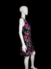 Load image into Gallery viewer, Black romper with colorful floral pattern on a mannequin against a white background