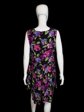 Load image into Gallery viewer, Black romper with colorful floral pattern on a mannequin, shown uncinched against a white background
