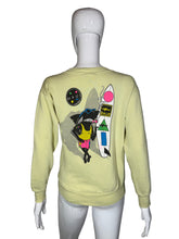 Load image into Gallery viewer, Light yellow sweatshirt with colorful graphic design on a mannequin against a gray background