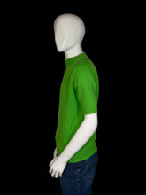 Load image into Gallery viewer, Mannequin wearing a green shirt and blue jeans on a white background