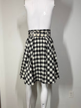 Load image into Gallery viewer, Mannequin wearing a black and white checkered skirt against a plain wall.