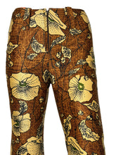 Load image into Gallery viewer, Floral-patterned fabric roll with yellow flowers on a brown background