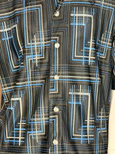 Load image into Gallery viewer, Close-up of fabric with geometric blue and white pattern on a black background