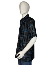 Load image into Gallery viewer, Mannequin wearing a black patterned shirt on a plain background