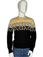 Load image into Gallery viewer, Front view of a mannequin wearing a patterned sweater with blue jeans.