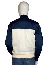 Load image into Gallery viewer, Mannequin wearing a navy and white jacket with blue jeans on a plain background