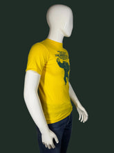 Load image into Gallery viewer, Mannequin wearing a yellow t-shirt with a graphic design on a plain background