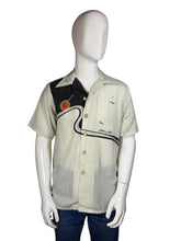 Load image into Gallery viewer, Mannequin wearing a short-sleeve shirt with a graphic design on a white background