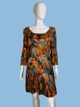 Load image into Gallery viewer, Mannequin wearing a floral dress with orange and black pattern against a plain background