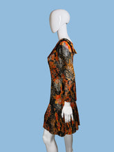 Load image into Gallery viewer, Mannequin wearing a colorful dress with abstract patterns on a plain background