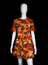 Load image into Gallery viewer, Mannequin wearing a colorful patterned dress against a plain background