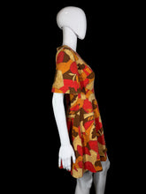 Load image into Gallery viewer, A mannequin wearing a colorful patterned dress against a white background