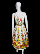 Load image into Gallery viewer, Floral dress on a mannequin against a plain background