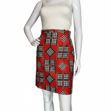 Load image into Gallery viewer, Mannequin wearing a white top and red patterned skort on a plain background.
