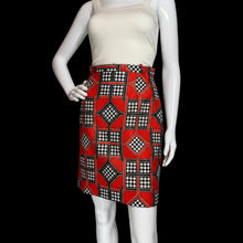 Load image into Gallery viewer, Mannequin wearing a white top and red patterned skort on a plain background.