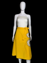 Load image into Gallery viewer, Yellow skirt with a white floral applique against a white background.