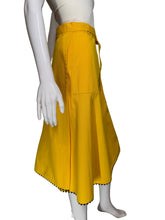 Load image into Gallery viewer, Yellow skirt with a white floral applique against a white background.