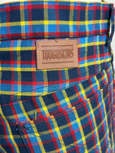 Load image into Gallery viewer, Plaid fabric with aToughskins label on a checkered pattern