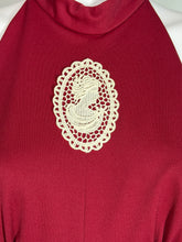 Load image into Gallery viewer, Red fabric with a white lace doily on top