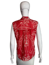 Load image into Gallery viewer, Mannequin wearing a red top with white graphics on a gray background