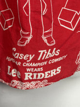 Load image into Gallery viewer, Red top with white text and graphics on a plain background