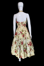 Load image into Gallery viewer, Floral dress on a mannequin against a plain wall.