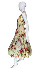 Load image into Gallery viewer, Mannequin wearing a floral dress in a room with a white wall and black door.