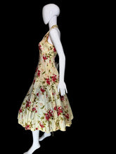 Load image into Gallery viewer, Mannequin wearing a floral dress in a room with a white wall and black door.