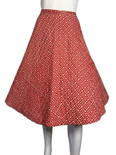 Load image into Gallery viewer, Red patterned skirt on a white surface