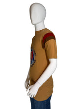 Load image into Gallery viewer, Mannequin wearing a brown t-shirt with a logo on a plain background