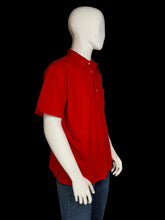 Load image into Gallery viewer, Red polo shirt on a mannequin against a plain background